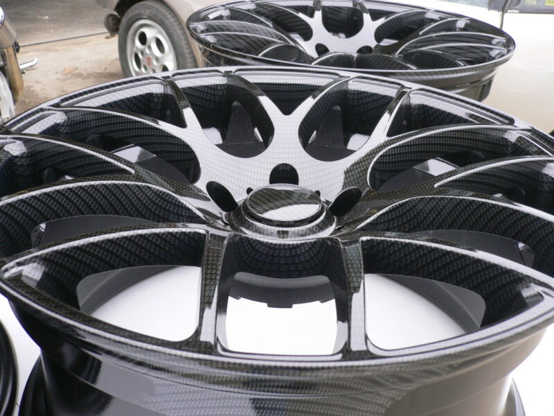 Car alloy wheels coated in carbon fibre