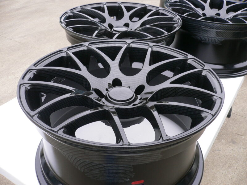 Car alloy wheels coated in carbon fibre