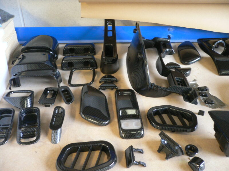 Car interior various elements coated in carbon fibre hydrographic film painted black