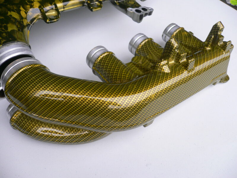 Car engine part coated in skull and carbon fibre painted yellow