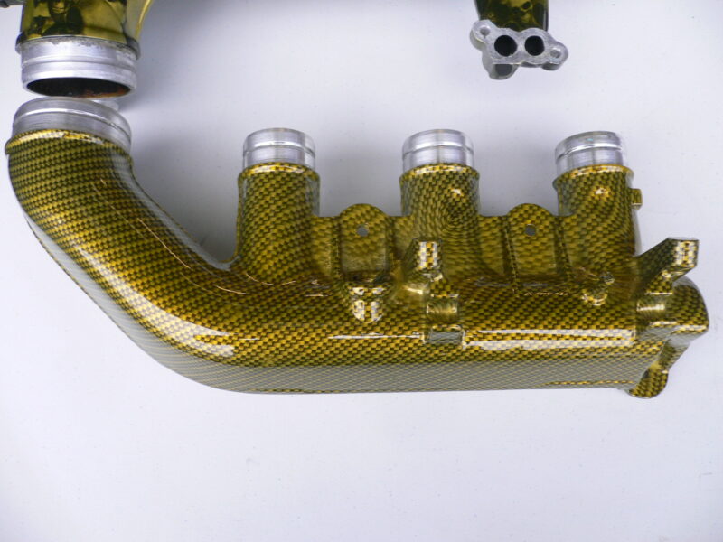 Car engine part coated in skull and carbon fibre painted yellow