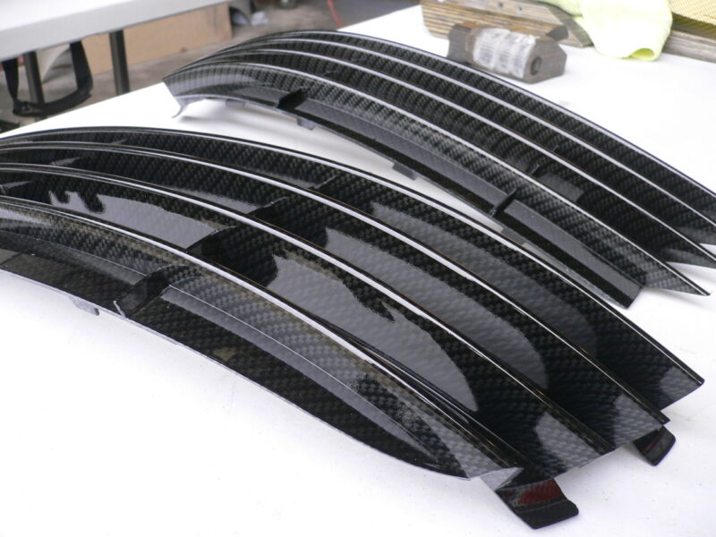 Car radiator cover coated in carbon fibre hydrographic film painted black