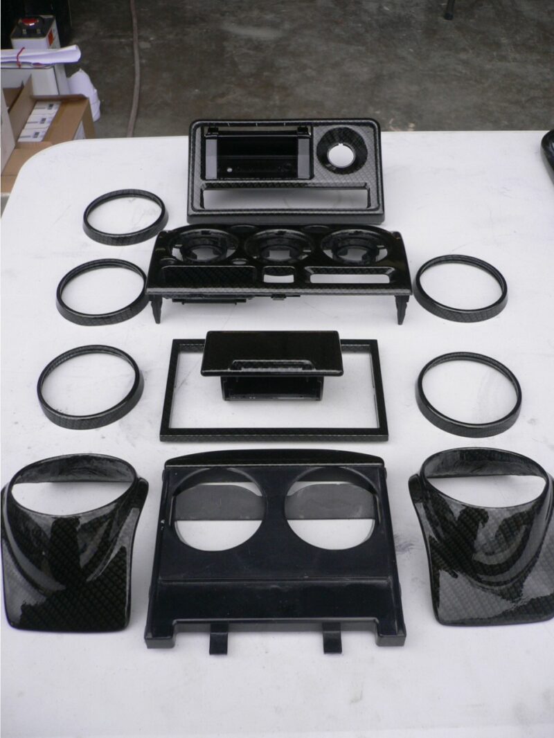Car interior various elements coated in carbon fibre hydrographic film painted black