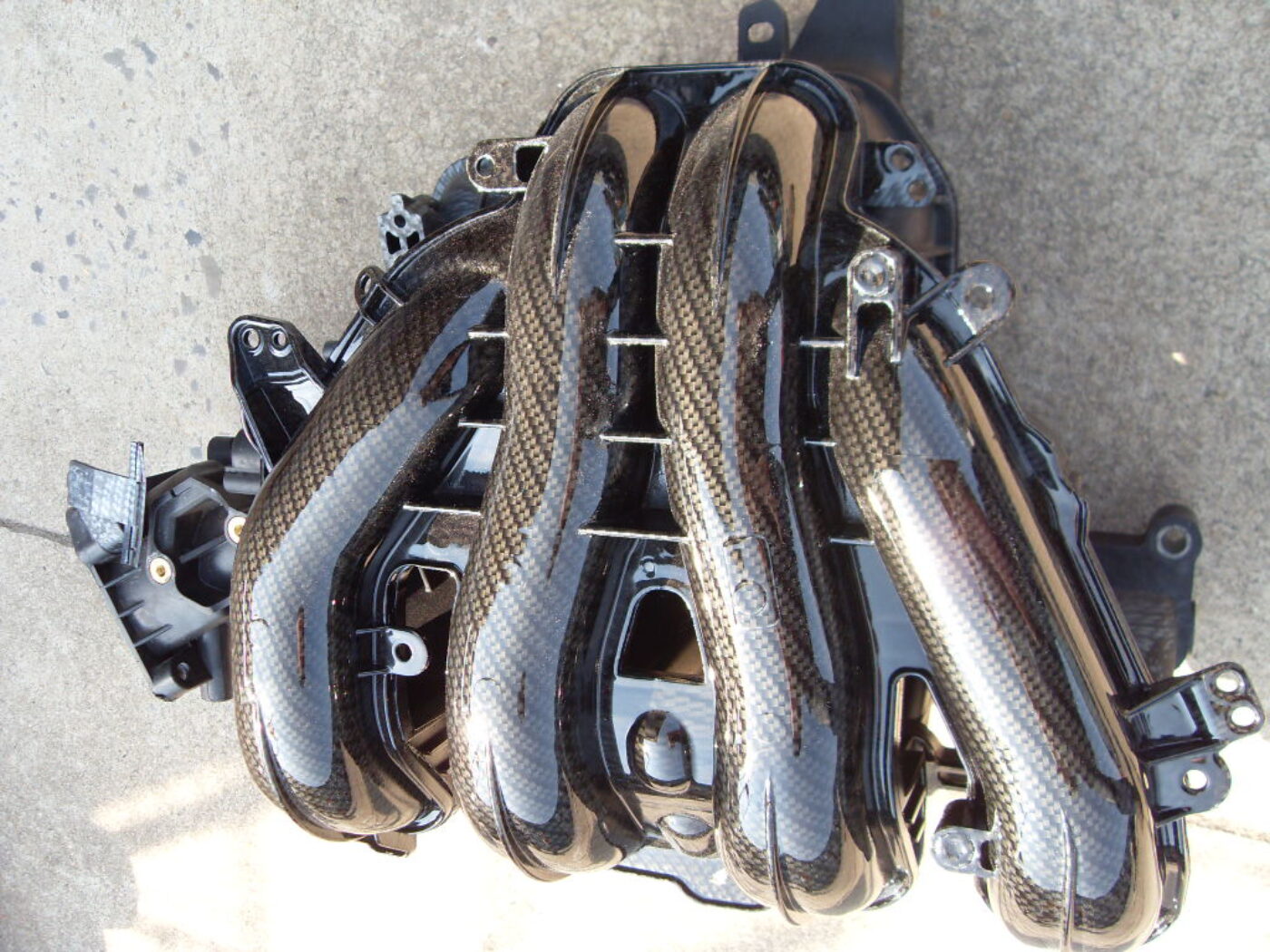 Car engine parts coated in carbon fibre