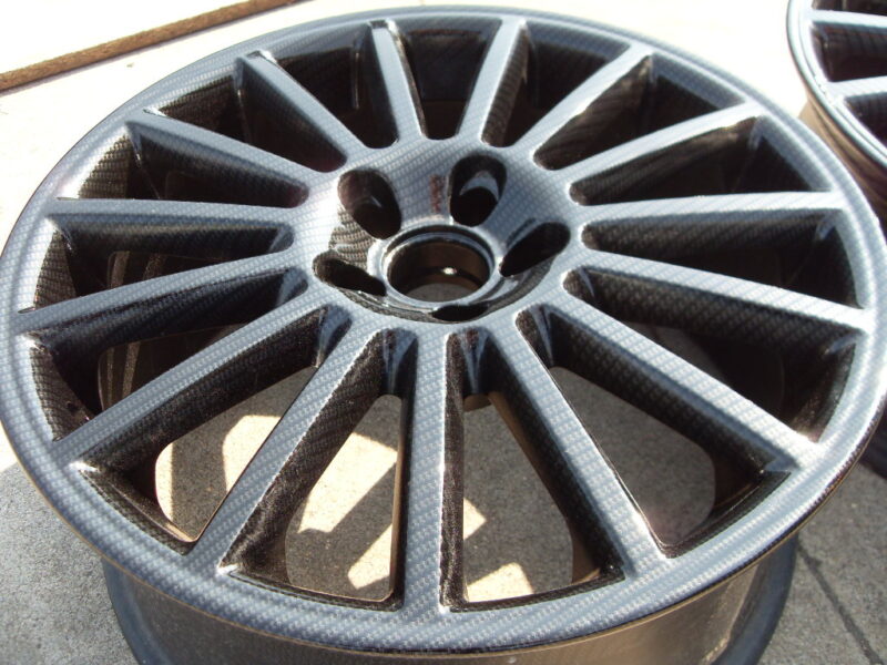 Car alloy wheels coated in carbon fibre