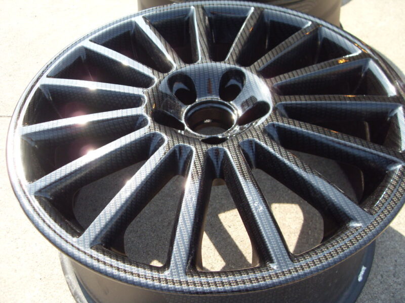 Car alloy wheels coated in carbon fibre