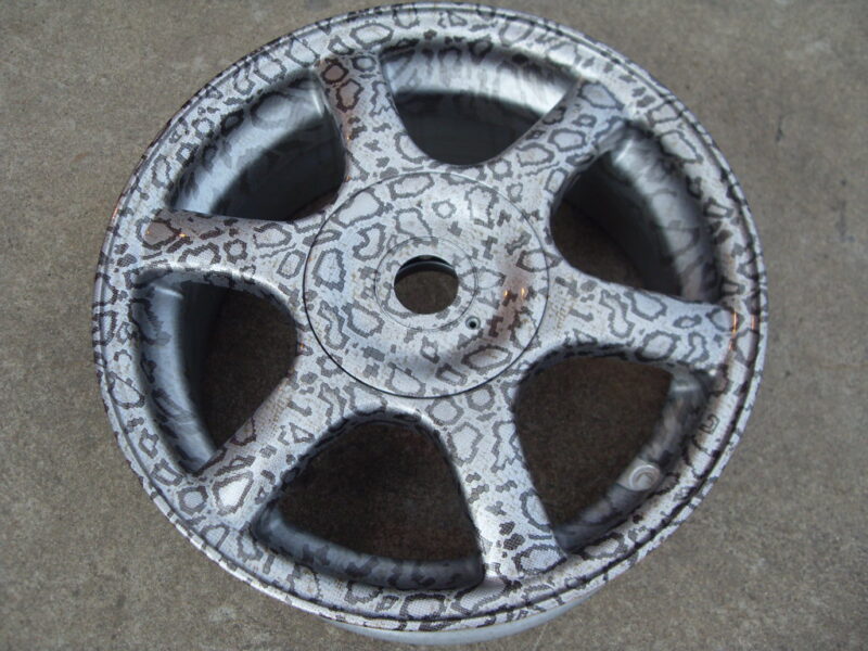 Car alloy wheels coated in panther hydrographic film