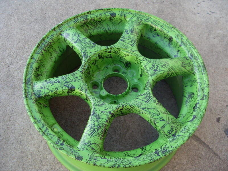 Car alloy wheels coated in skull painted green