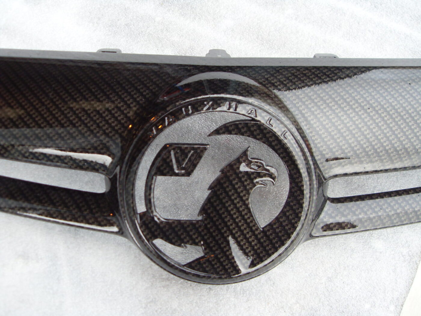 Various car exterior coated in carbon fibre