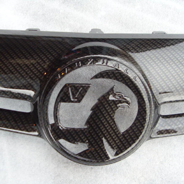 Various car exterior coated in carbon fibre