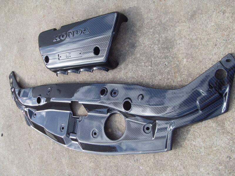 Honda engine cover coated in carbon fibre hydrographic film painted black
