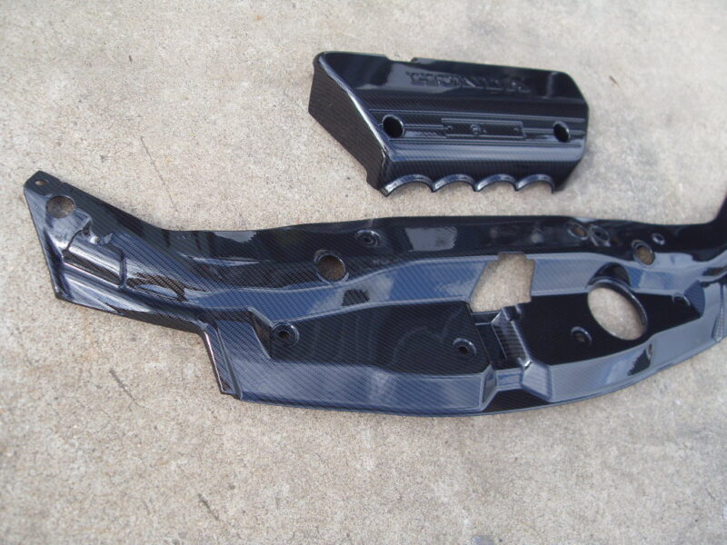 Honda engine cover coated in carbon fibre hydrographic film painted black