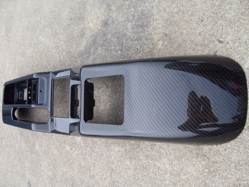 Car interior parts coated in carbon fibre hydrographic film painted black