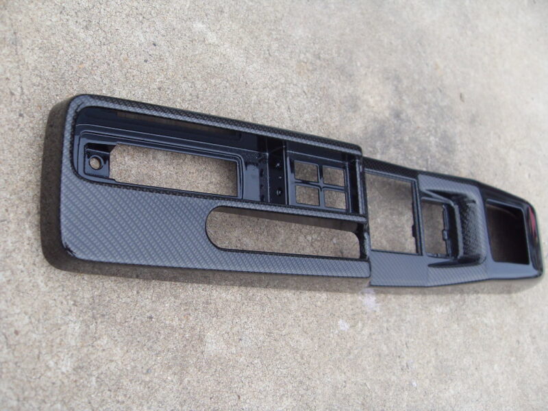 Car interior parts coated in carbon fibre hydrographic film painted black