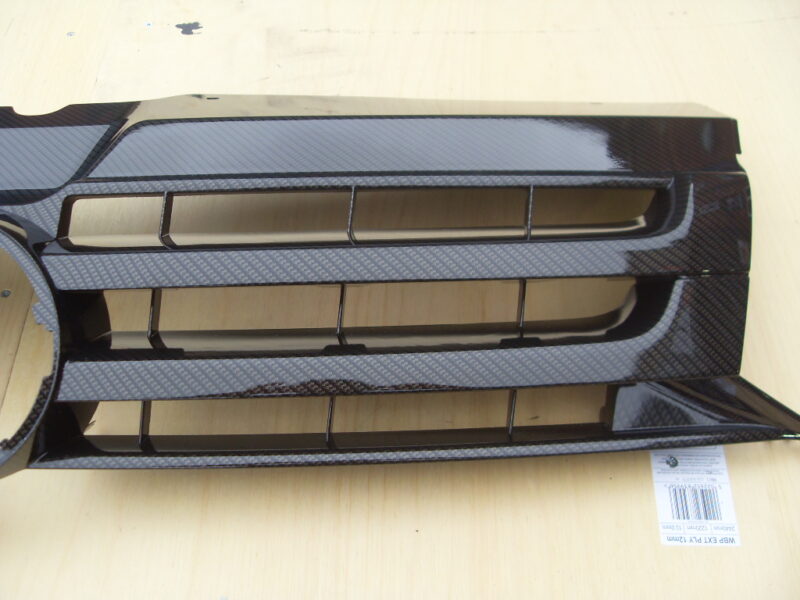 VW radiator cover coated in carbon fibre hydrographic film painted black