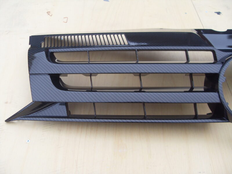 VW radiator cover coated in carbon fibre hydrographic film painted black