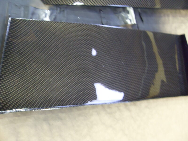 Car hood coated in carbon fibre hydrographic film painted black