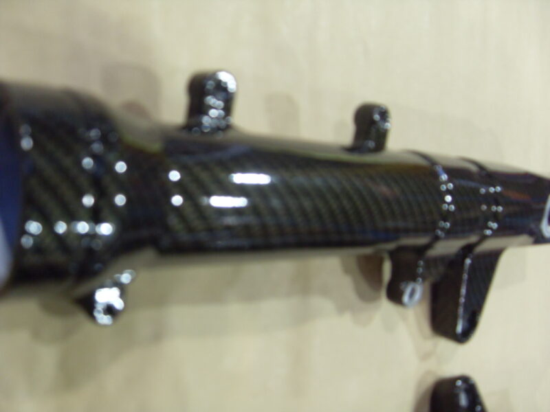 Motorbike parts coated in carbon fibre hydrographic film painted black