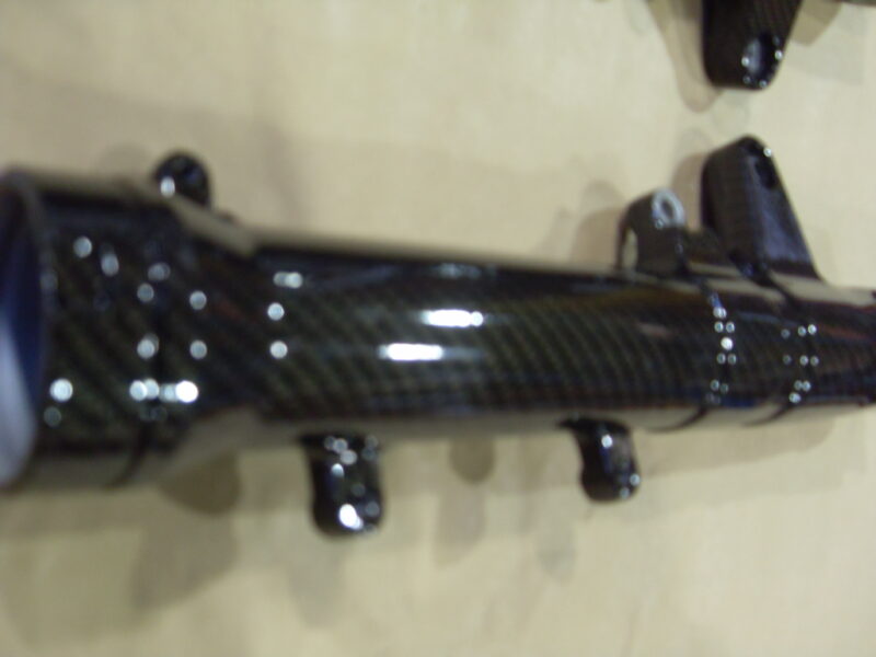 Motorbike parts coated in carbon fibre hydrographic film painted black