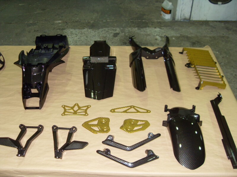 Motorbike various parts coated in carbon fibre hydrographic film painted black and yellow