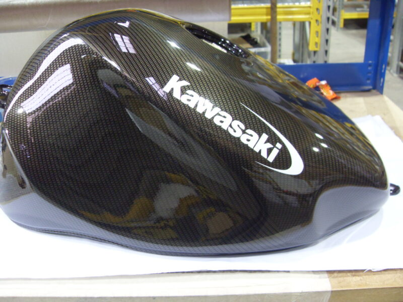 Motorbike tank coated in carbon fibre hydrographic film painted black