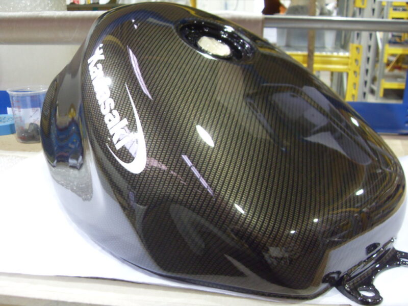 Motorbike tank coated in carbon fibre hydrographic film painted black