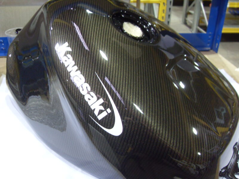 Motorbike tank coated in carbon fibre hydrographic film painted black