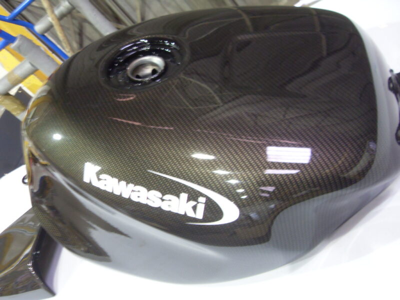 Motorbike tank coated in carbon fibre hydrographic film painted black