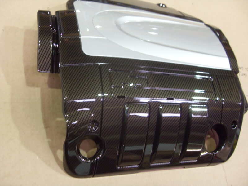 Engine cover coated in carbon fibre hydrographic film painted black