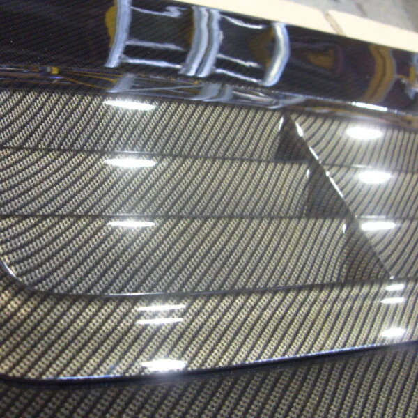 Car hood coated in carbon fibre hydrographic film painted grey