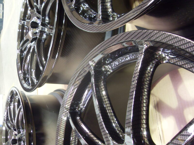 Car alloy wheels coated in carbon fibre painted black