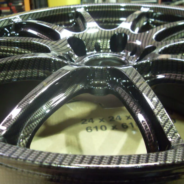 Car alloy wheels coated in carbon fibre painted black