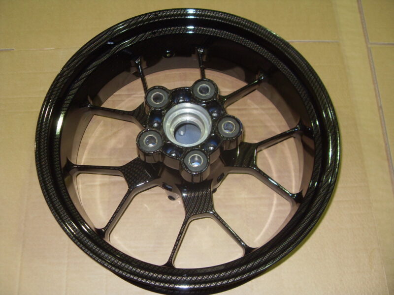 Motorbike alloy wheels coated in carbon fibre painted black