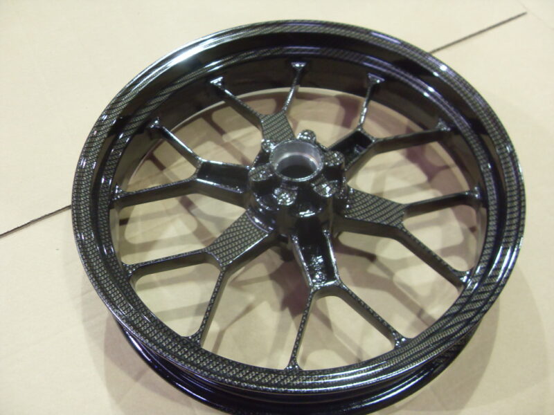 Motorbike alloy wheels coated in carbon fibre painted black