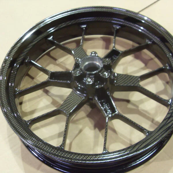 Motorbike alloy wheels coated in carbon fibre painted black