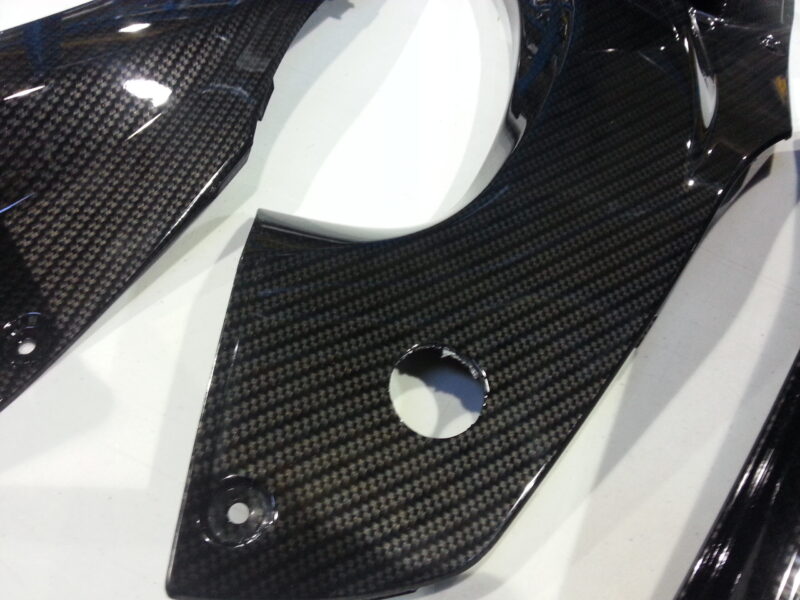 Motorbike parts coated in carbon fibre hydrographic film painted black