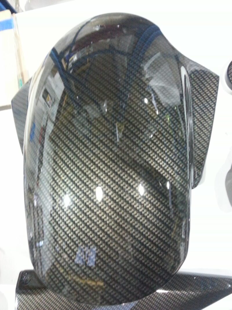 Motorbike parts coated in carbon fibre hydrographic film painted black