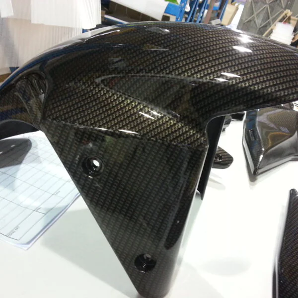Motorbike parts coated in carbon fibre hydrographic film painted black