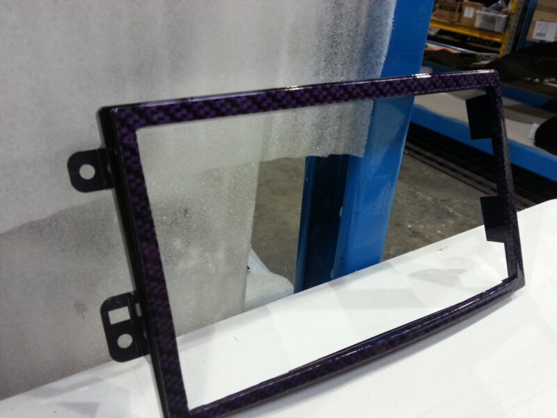 Car dashboard elements coated in carbon fibre hydrographic film painted purple