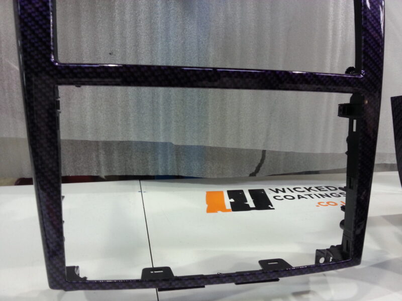 Car dashboard elements coated in carbon fibre hydrographic film painted purple