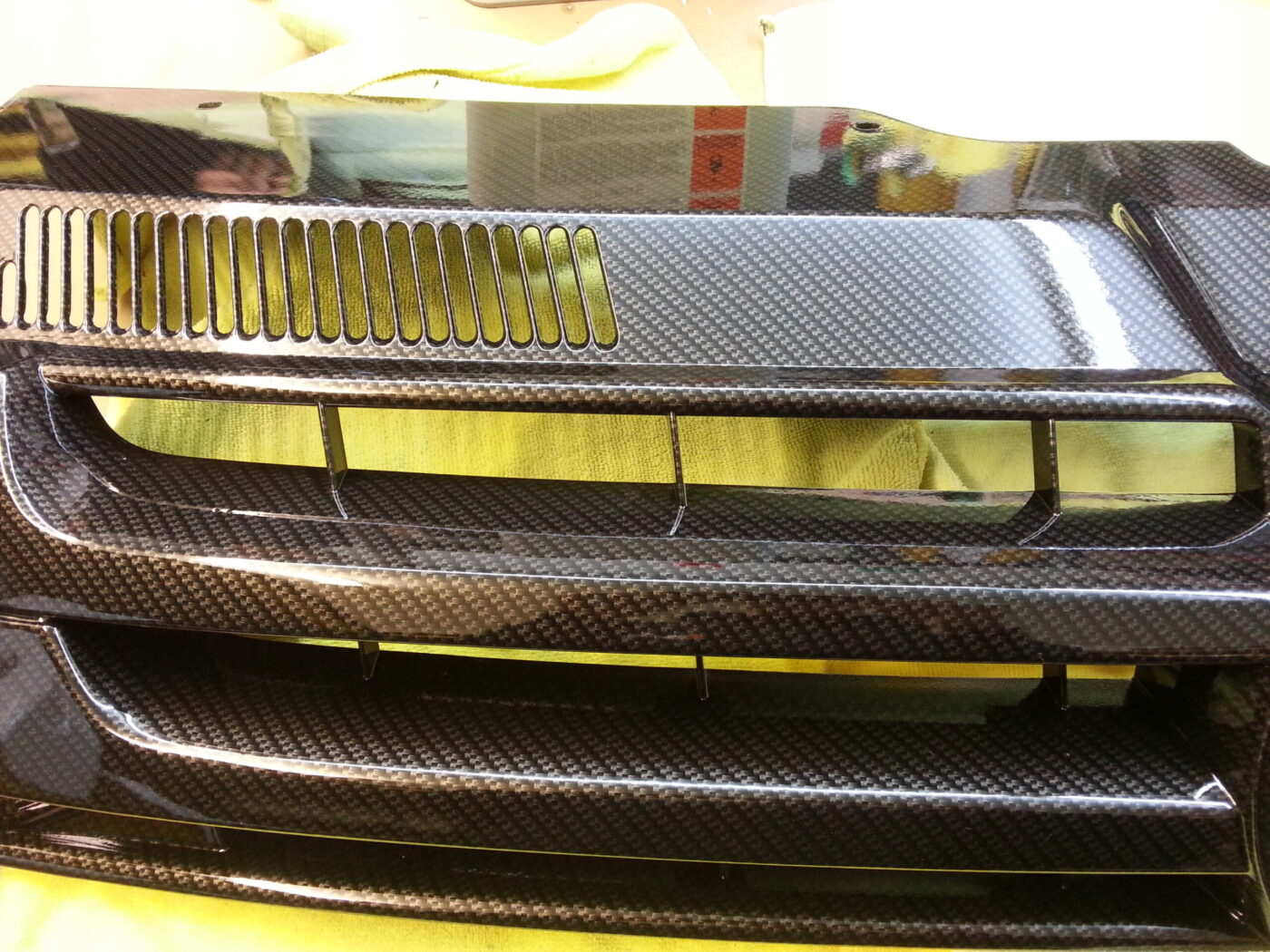 VW radiator grill coated in carbon fibre hydrographic film painted black