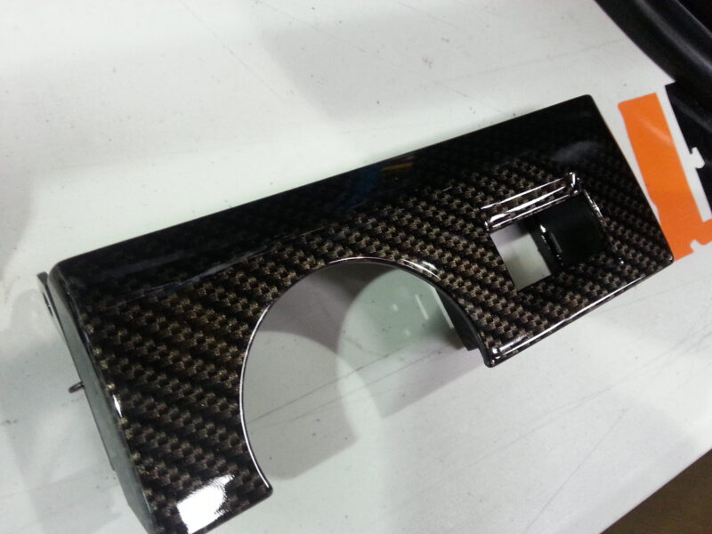 Car alloy wheels coated in carbon fibre hydrographic film painted black