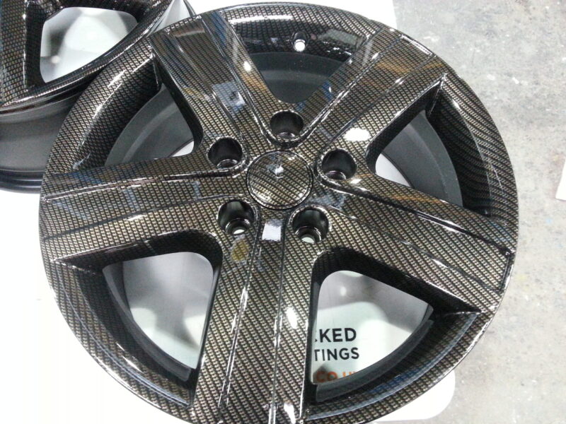 Car alloy wheels coated in carbon fibre hydrographic film painted black