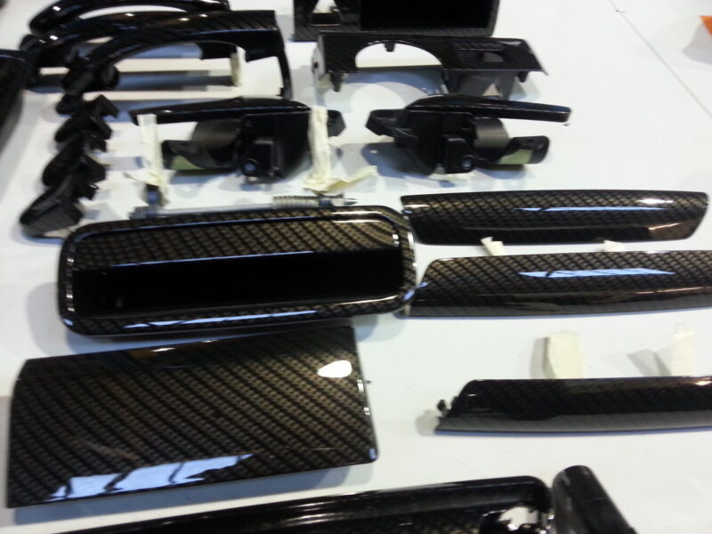 Car interior various elements coated in carbon fibre hydrographic film painted black