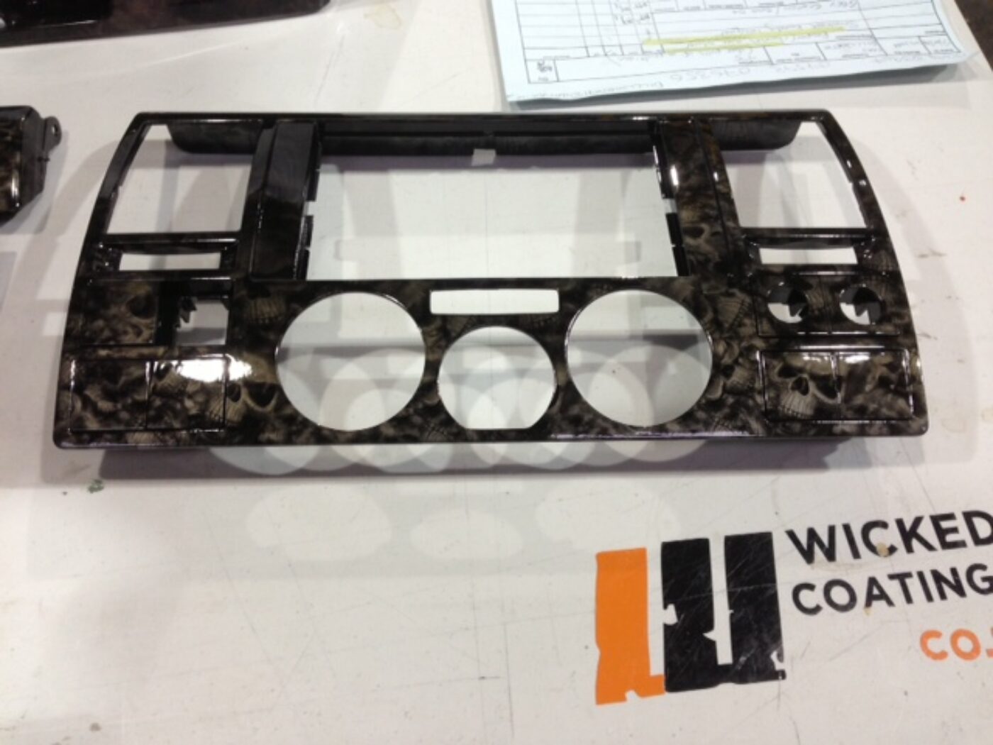 Car dashboard elements coated in skull hydrographic film painted black
