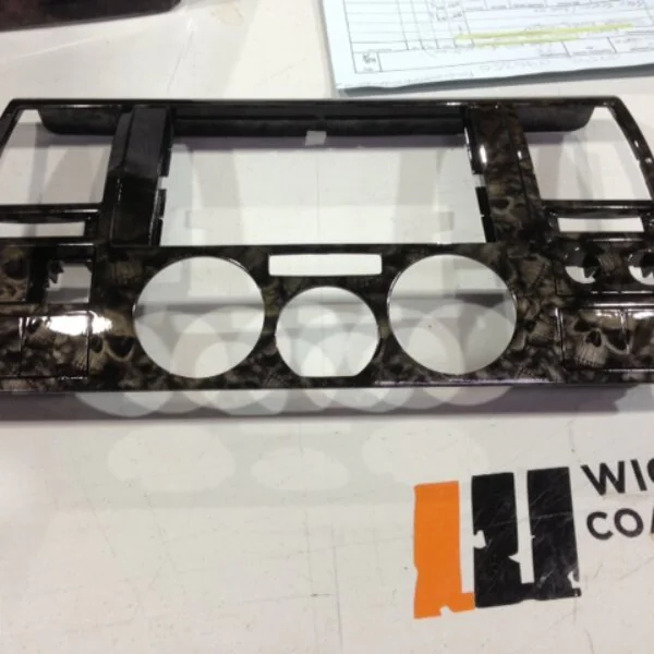 Car dashboard elements coated in skull hydrographic film painted black