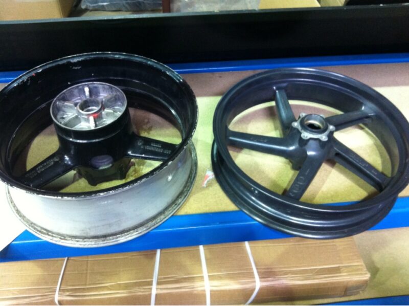 Motorbike alloy wheels coated in carbon fibre painted dark red