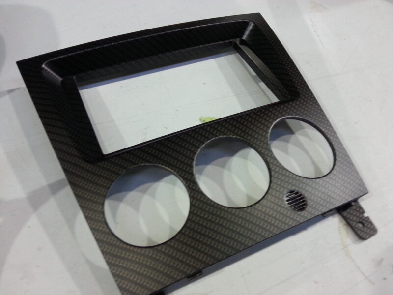 Car dashboard elements coat in carbon fibre hydrographic film painted black