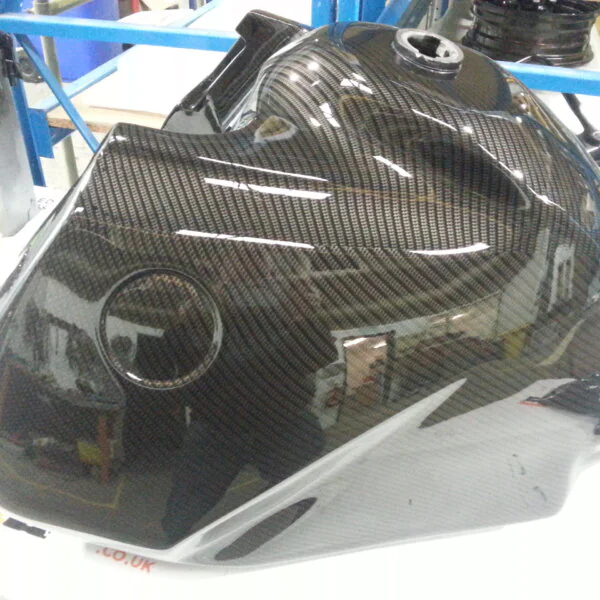 Motorbike tank coated in carbon fibre painted black