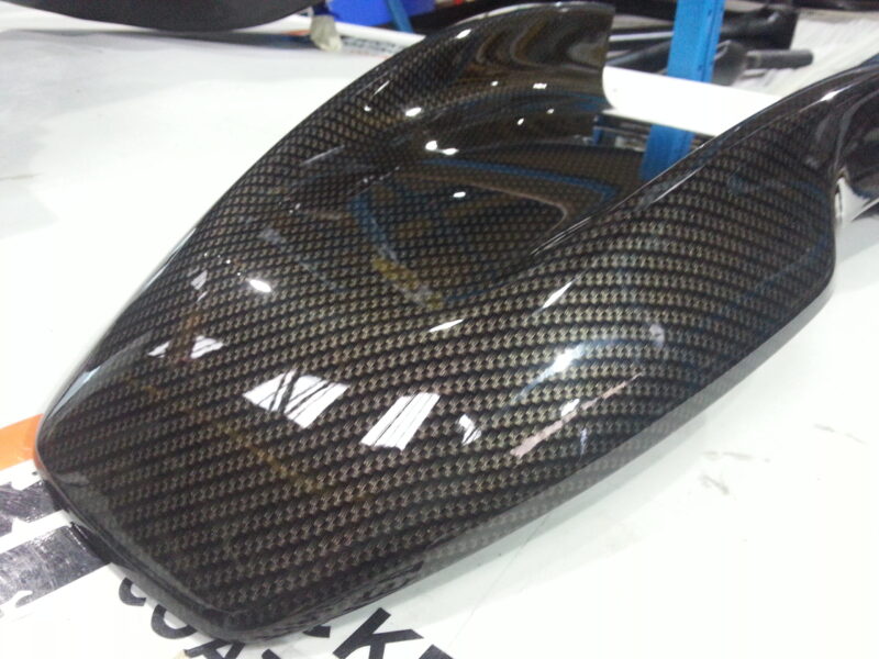 Motorbike tank coated in carbon fibre painted black